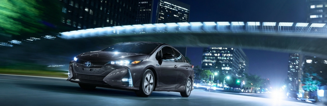 2018 Toyota Prius Prime driving down the road.