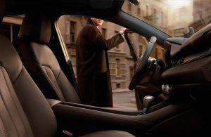 Person standing with door open outside of the 2020 Mazda6