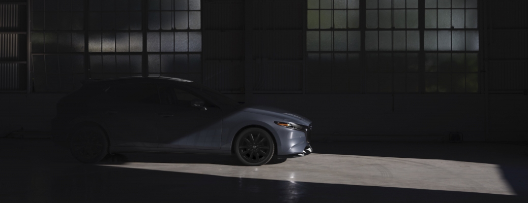 2021 Mazda3 gray side view mostly obscured by darkness