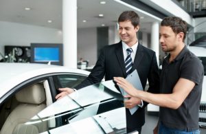 salesman showing car to customer