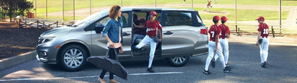 A family getting out of a 2020 Honda Odyssey
