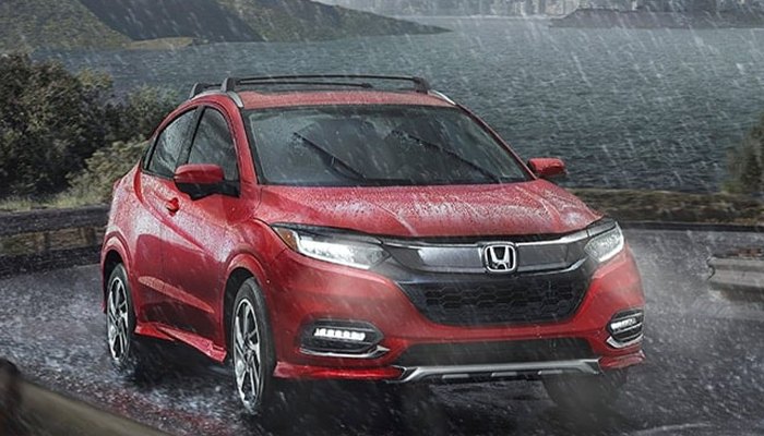 2020 Honda CR-V driving down a winding road in the rain