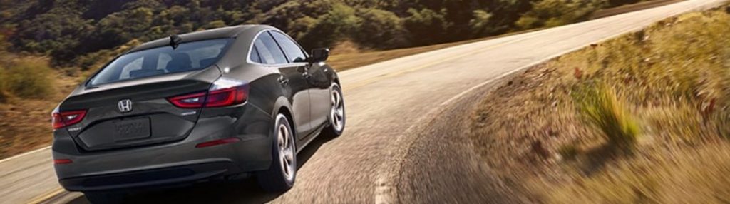 2021 Honda Insight driving down a winding path
