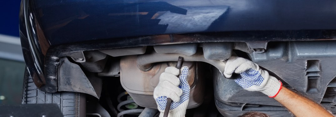 A man working on the underside of a vehicle