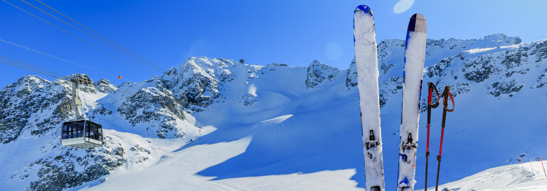Skis-and-poles-stuck-in-snow-on-ski-mountain