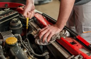 Mechanic-dipping-oil-stick