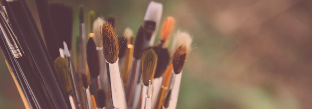Close-up on paintbrushes in a container