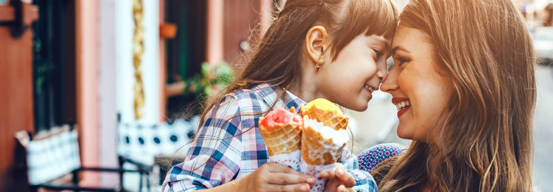 mom with her daughter face to face with ice cream