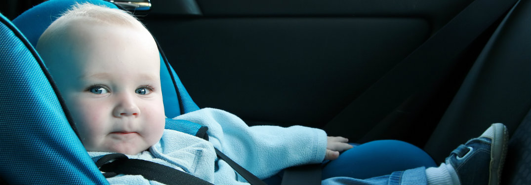 baby sitting in a car seat
