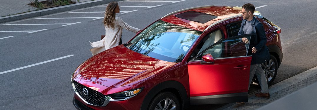 A couple getting into a 2020 Mazda CX-30