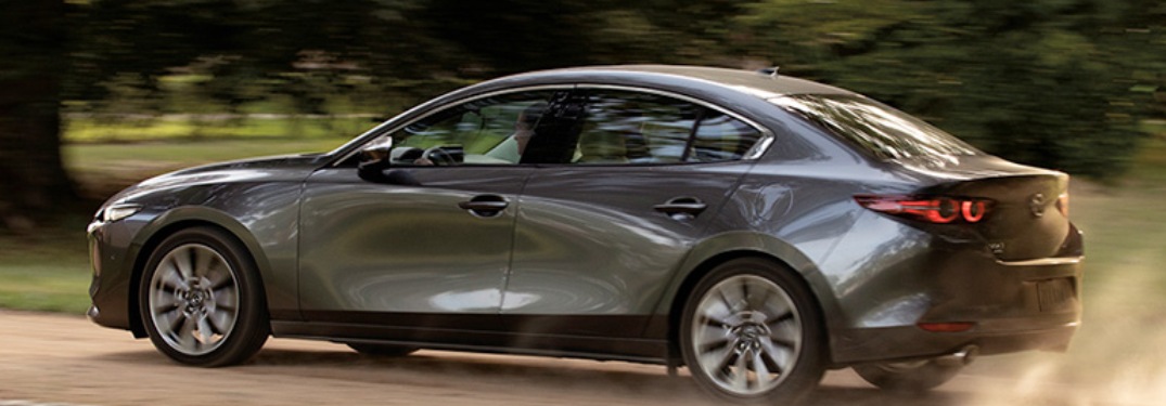 2020 Mazda3 Sedan driving down a dirt road