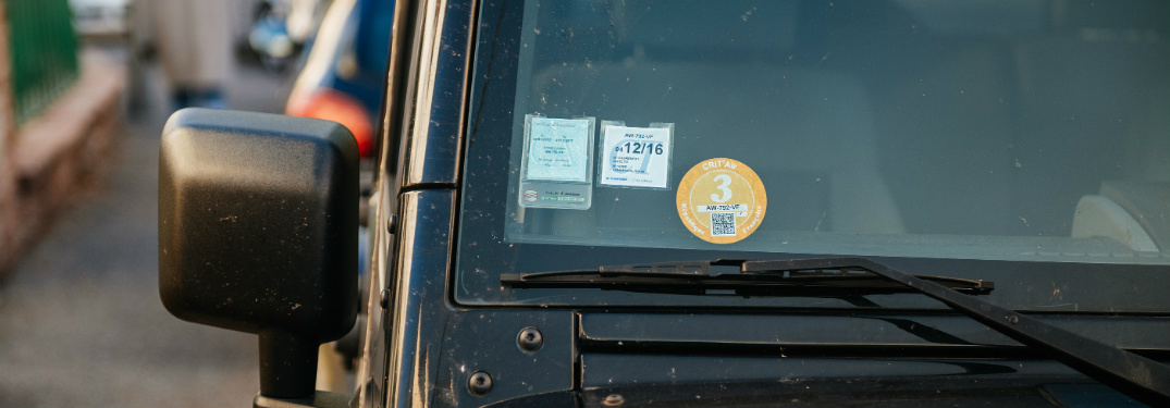 multiple stickers on windshield of vehicle