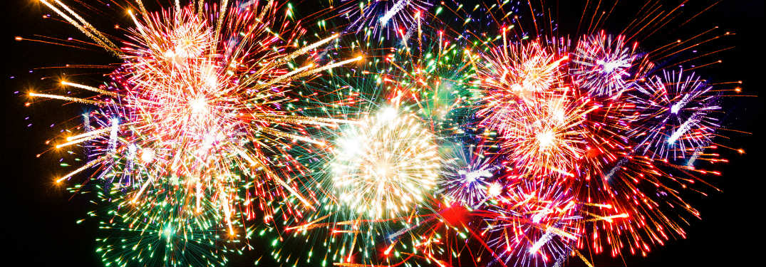multitudes of fireworks of all different colors in night sky