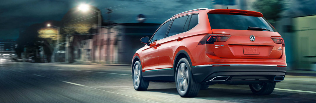 2018 Volkswagen Tiguan driving down a street at night