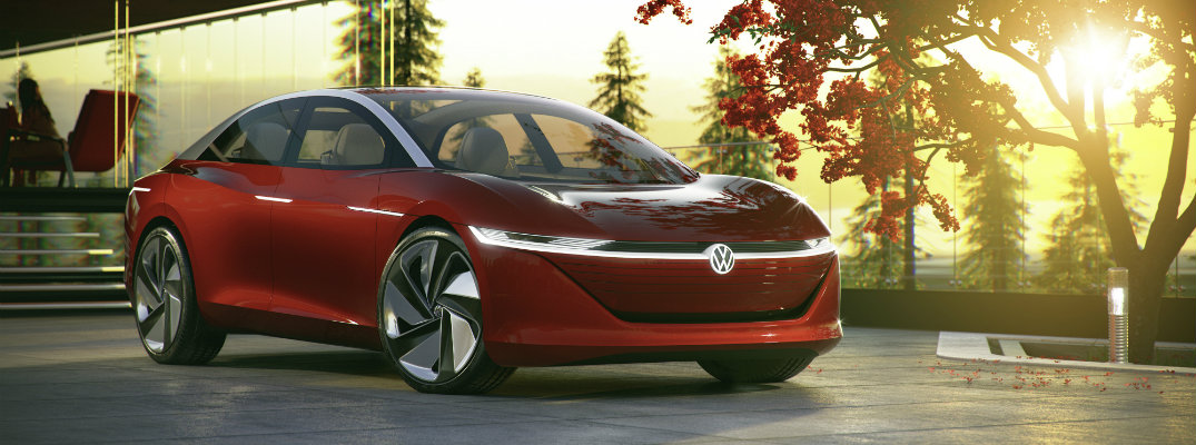 volkswagen i.d. vizzion concept all-electric parked outside luxury forest house at sunset