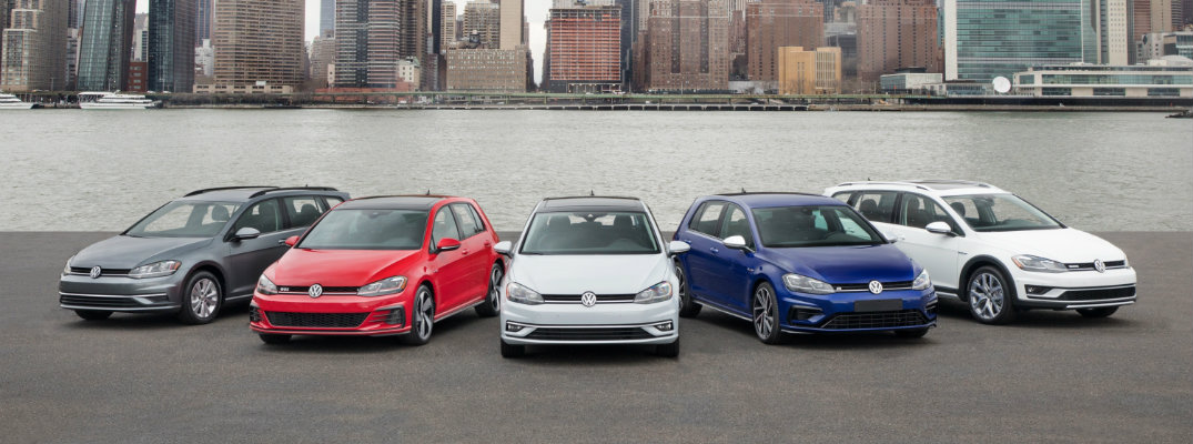 2018 Volkswagen Golf family line up on a beach with a river and a cityscape skyline in the background