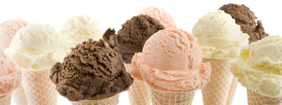 chocolate, vanilla, and strawberry scoops of ice cream on waffle cones