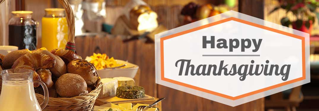 Happy Thanksgiving title with a basket of bread rolls and a pitcher of juice