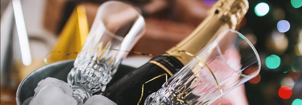 Champagne and glasses in a bucket of ice