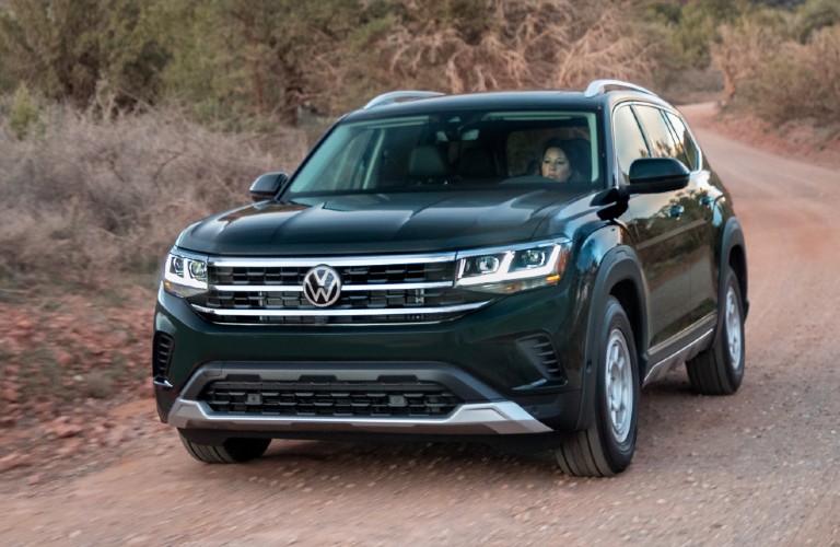 Driver's side front angle view of green Volkswagen Atlas with Basecamp accessory line