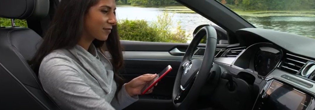 A women using her smartphone to enroll in Volkswagen Car-Net