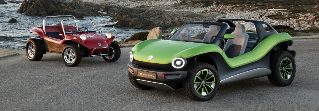 Green Volkswagen ID. Buggy Concept and a classic red California dune buggy parked near the ocean