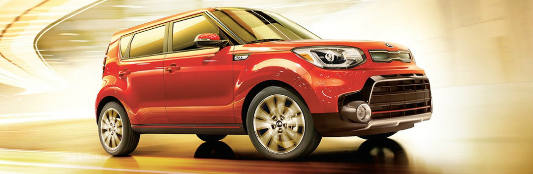 2019 Kia Soul Red in front of burst yellow background