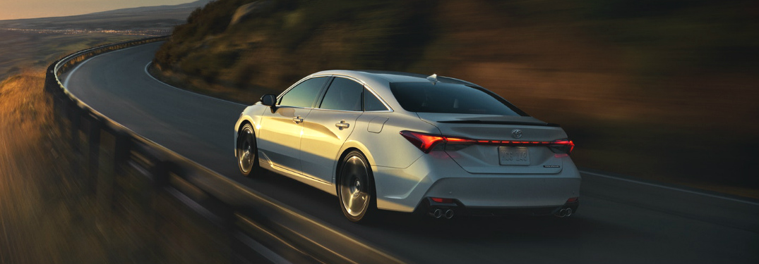 2019 Toyota Avalon driving on a twisty mountain road at sunset