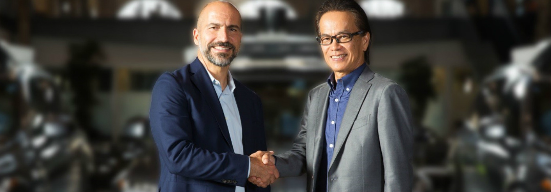 Toyota and Uber executives shaking hands