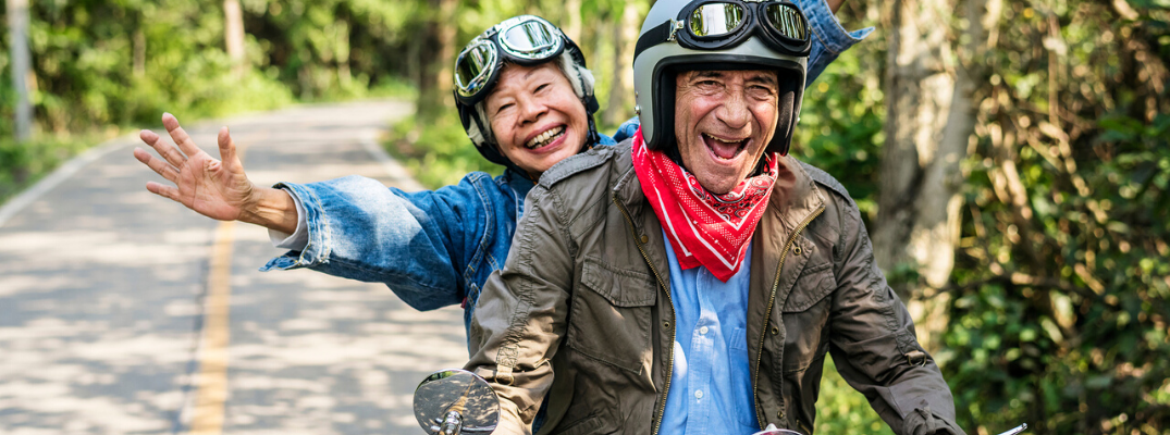 Elderly couple riding on motorbike