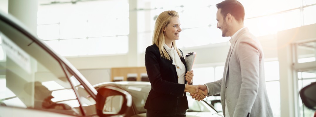 A stock photo of a customer completing a deal with a handshake.