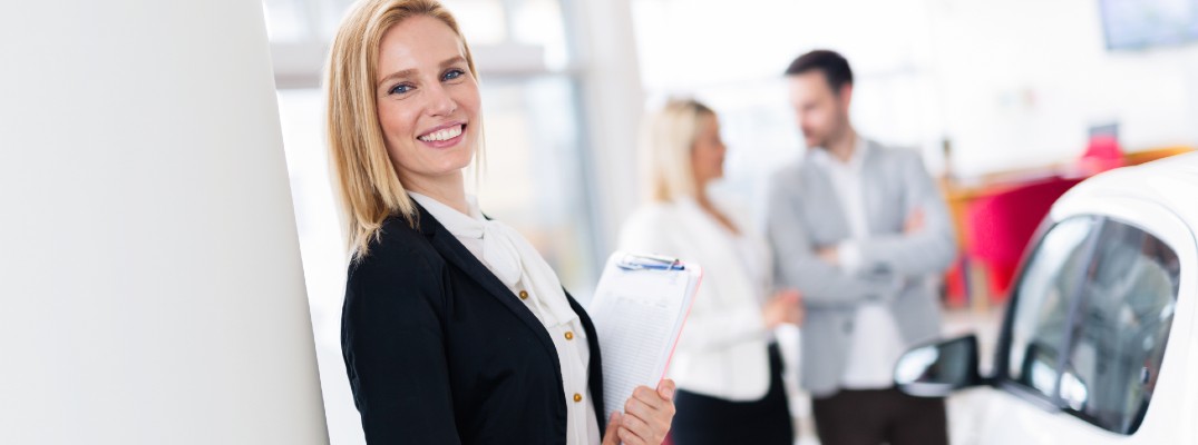 A stock photo of a sales person getting ready to help some customers.