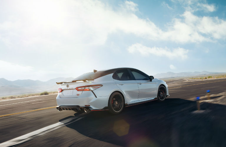 A rear right quarter photo of the 2020 Toyota Camry on the road.