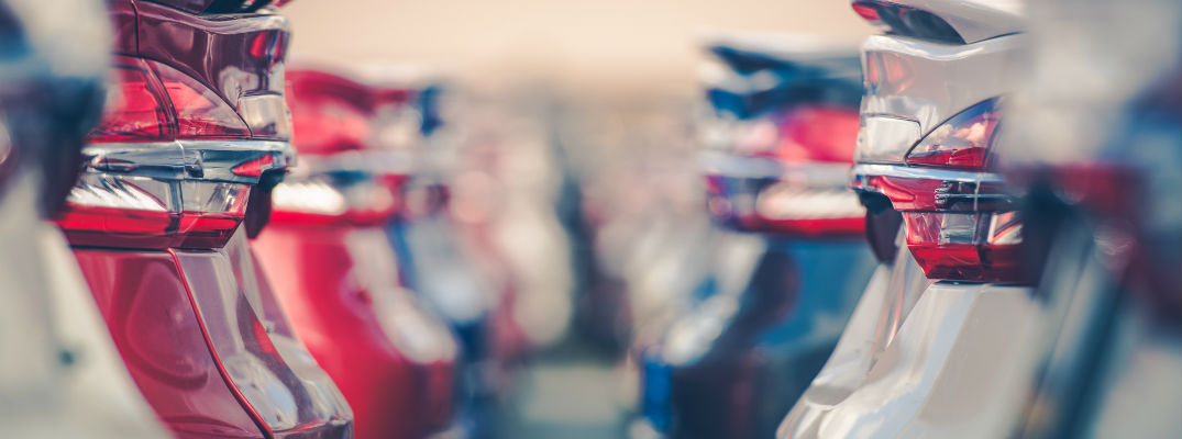 A stock photo of cars lined up at a dealership.
