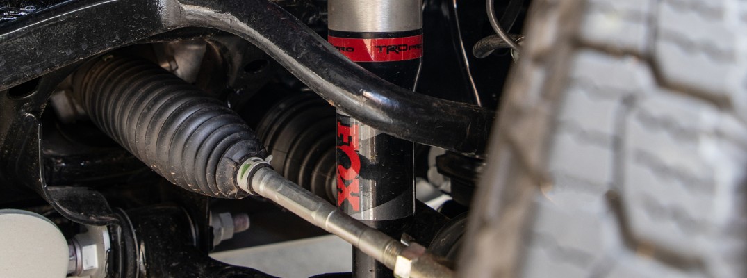 A photo of a TRD shock absorber attached to a Toyota vehicle.