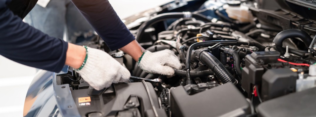 A stock photo of a technician working on a vehicle.