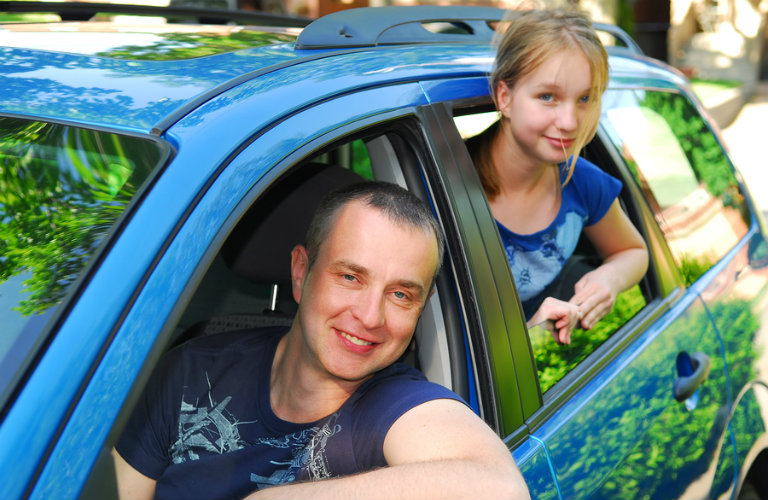 man and girl in blue car