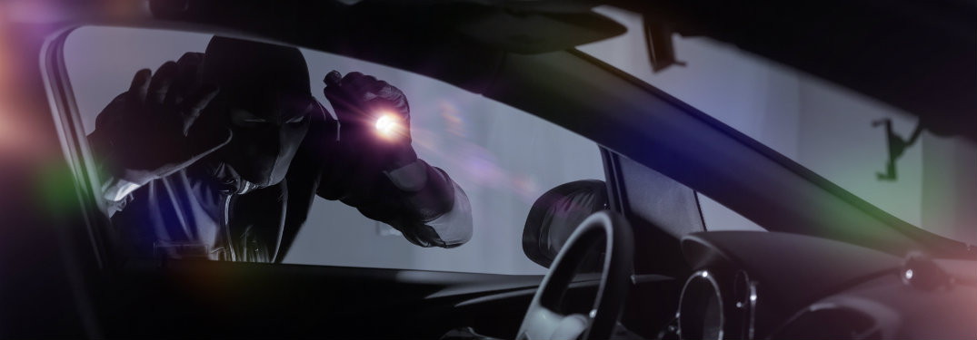 robber with flashlight looking into car