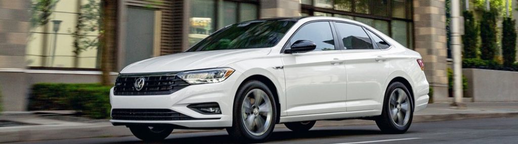 2020 Volkswagen Jetta driving down a city street