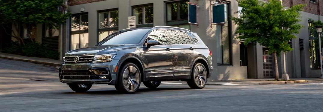 The front image of a gray 2020 Volkswagen Tiguan parked in a city area.