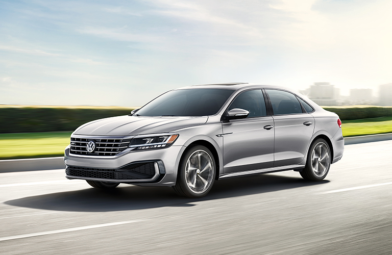 A gray 2020 Volkswagen Passat driving down an open road.