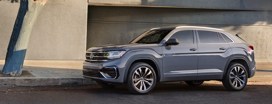 A gray 2020 Volkswagen Atlas Cross Sport parked near a building.