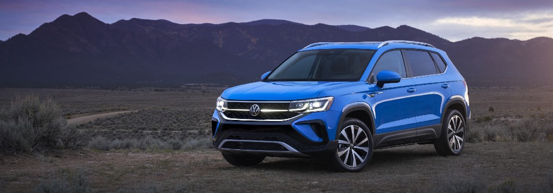 The front and side image of a blue 2022 Volkswagen Taos.