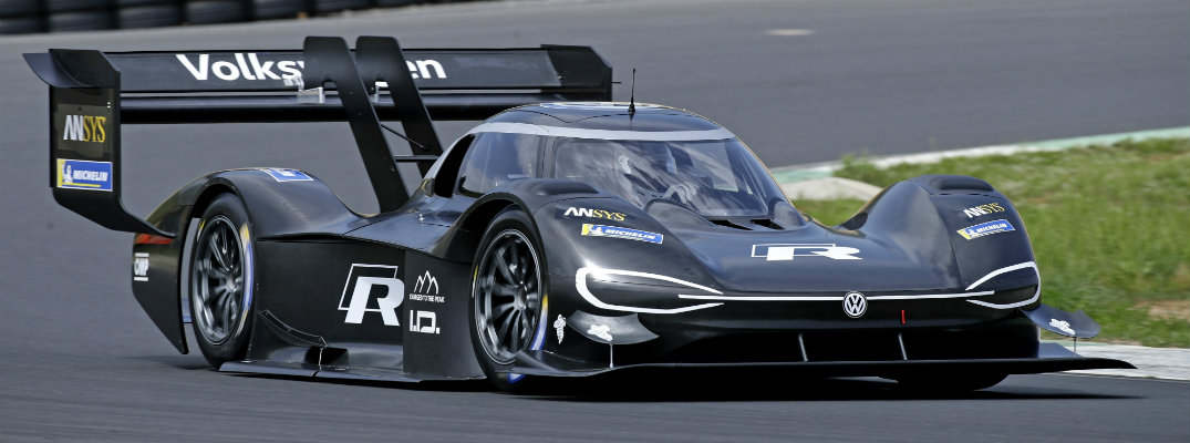 Volkswagen I.D. R Pikes Peak electric race car concept parked on the race track near grass and tire walls
