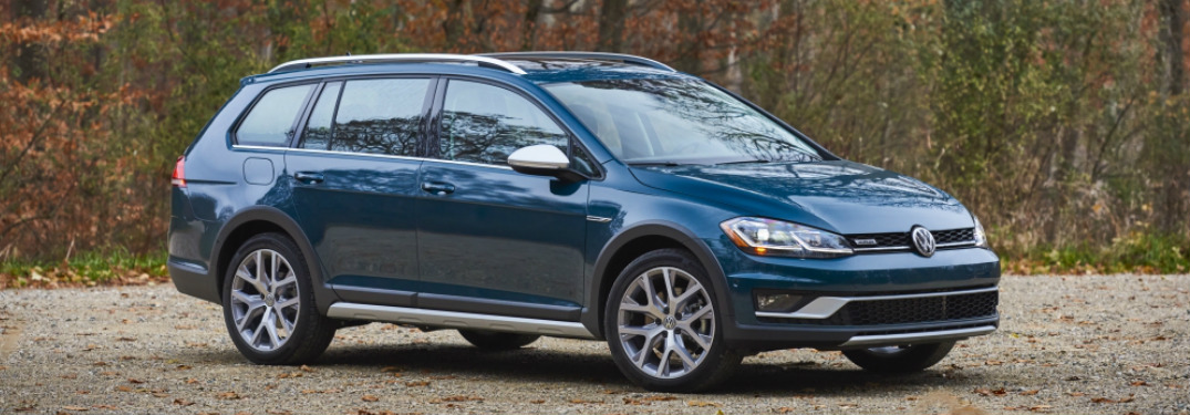 Blue 2018 Volkswagen Golf Alltrack Parked next to a Forest
