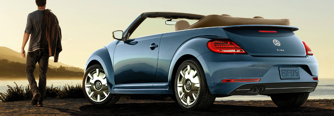 Man Standing in Front of a Blue 2018 VW Beetle Convertible