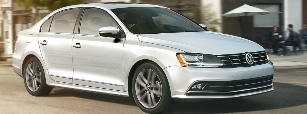 White 2018 VW Jetta Driving on a City Street