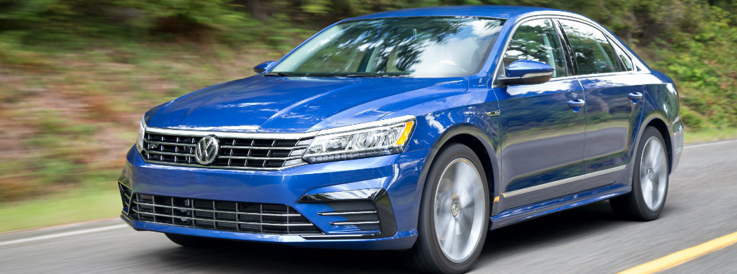 2018 Volkswagen Passat R-Line package blue paint color exterior shot driving down a forest road