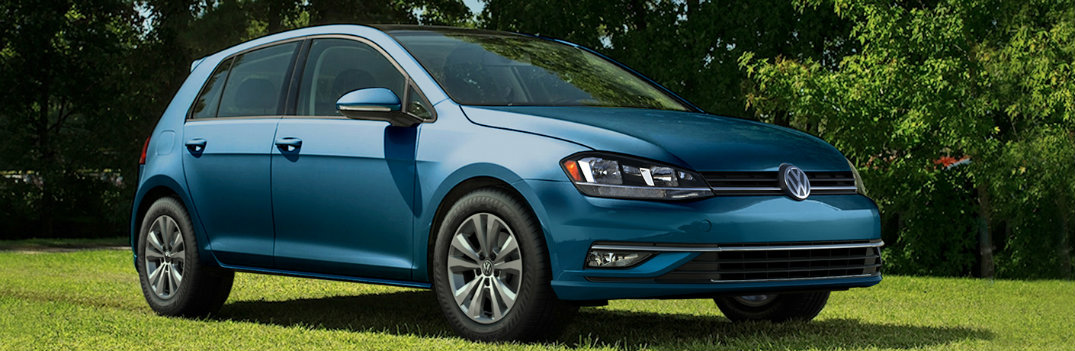 2018 Volkswagen Golf Teal parked in the shade and sun on green grass background