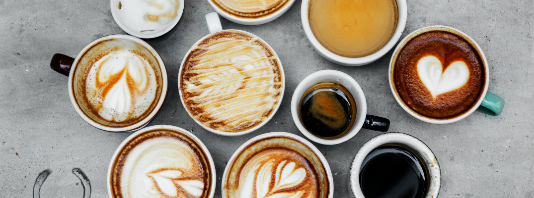 aerial overhaed view of various cup and mugs of coffee and tea